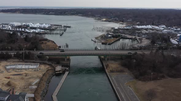 An aerial view over the Shinnecock Canal in Hampton Bays, Long Island, NY. The drone camera dolly in alt