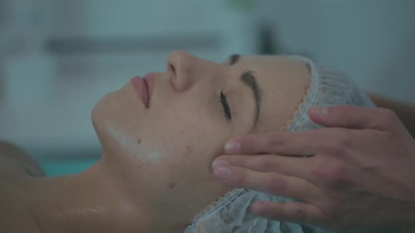 Closeup of a Girl Doing a Cosmetic Procedure Facial Massage