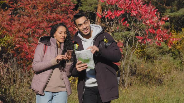 Happy Young Couple in Love Hiking Tourists Backpacking Outdoors Talking Discussing Arguing Guy Looks alt