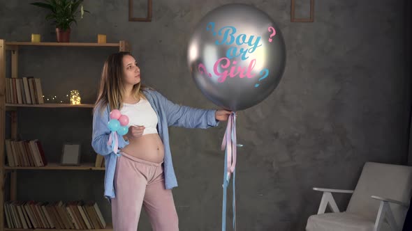 Big Balloon with the Words Girl or Boy Baby Gender Disclosure Party Pregnant Woman with Belly Baby alt