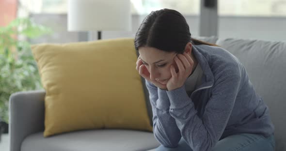 Sad depressed woman self-isolating at home alt