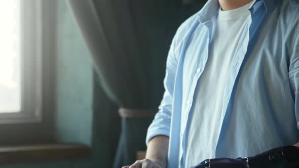 Disabled guy with artificial bio hand prothesis on large table alt