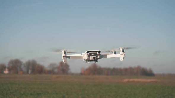 White Drone Hanging in Air or Flying on Nature Background 4K Shot	 alt