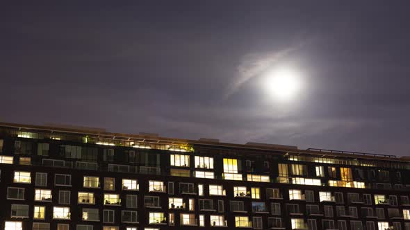 Time-lapse of the exterior of a modern apartment block at night