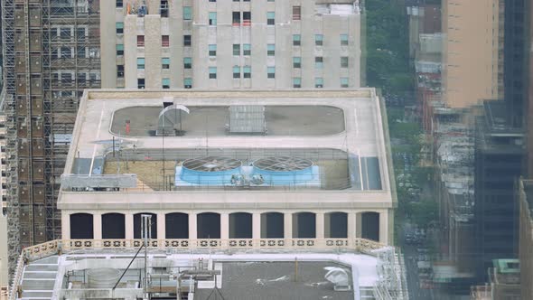 Fans of Air Conditioning System Spinning on Roof Top of Skyscraper New York alt