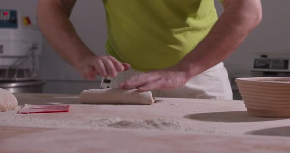 Slow Motion of Hands of Baker Chef Applying Flour on Dough