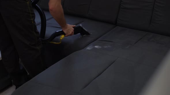 Removing Dirt From Sofa with Upholstery Cleaner Closeup
