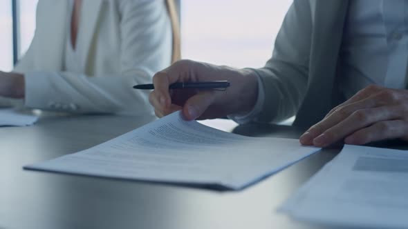 Closeup Hands Checking Agreement in Office alt