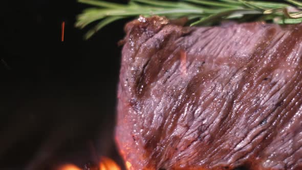 Juicy meat grill. piece of meat is grilled on grate grill picnic outside house. alt