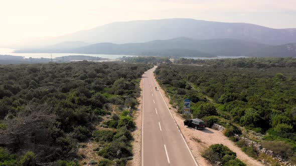 Aerial view of pro biker riding downhill at competition, Croatia. alt