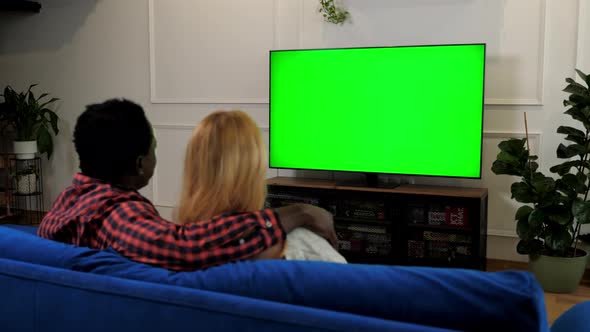 Green Screen TV Multiethnic Family Couple Embrace Watching Movie Series on TV alt
