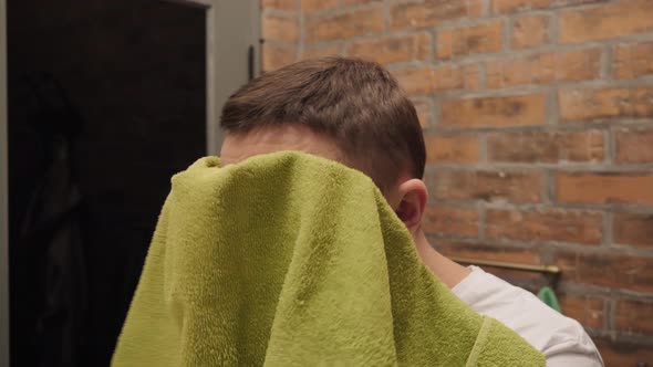 The Man Wipes His Face with a Towel