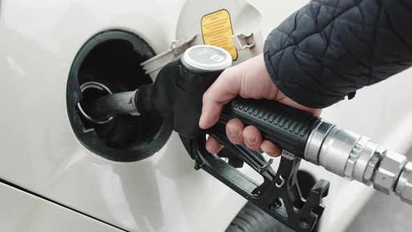 Hand Puts Diesel Fuel Pump Into Car alt