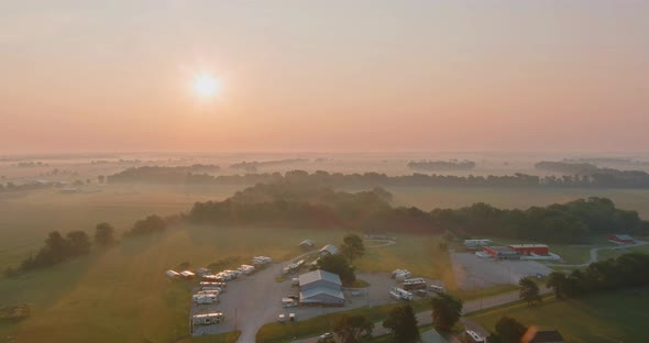 Rural Landscape at Sunrise with Road in a Field on a Foggy Spring Morning alt