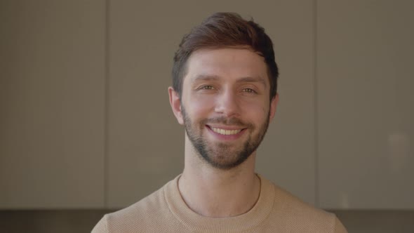 Portrait of a smiling man looking at camera, slow motion concept alt