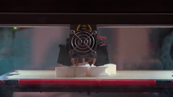 Closeup of 3d Printer in Process of Creating Some White Shape Figure alt