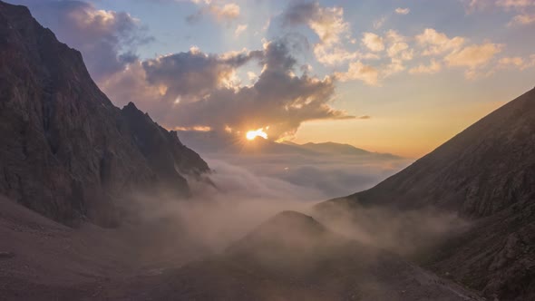 Mountains and Moving Clouds at Sunset. Aerial Hyper Lapse alt