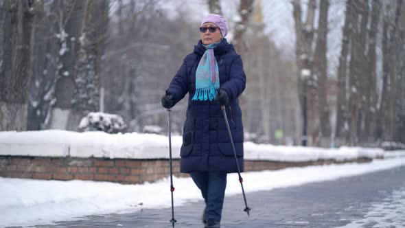 Active Senior Elderly Woman Training Nordic Walking with Trekking Poles, Elderly Woman Practicing