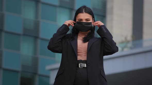 Young Hispanic Girl Standing on City Building Background Looking at Camera Businesswoman Wearing alt