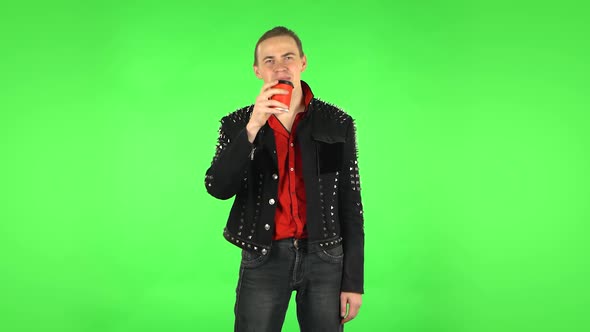 Guy Enjoying Coffee on Green Screen alt