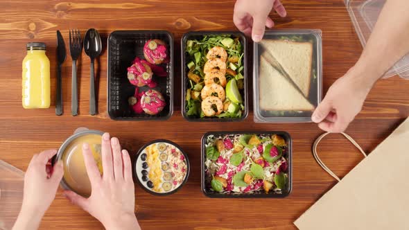 Food Delivery Top View Closing Take Away Meals in Disposable Containers on Wooden Table alt