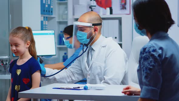 Doctor Listening Child Breath with Stethoscope alt