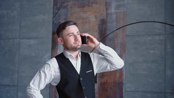 Successful Happy Businessman Luxurious Black Suit is Dialing Calling Through His Modern Smartphone alt