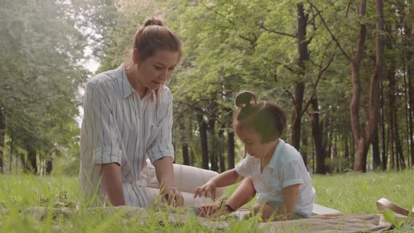 Mother and Little Son Playing on Grass in Summer alt
