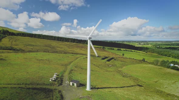 Ireland Green Farmland Windmill Aerial View Blades Spin Power Plant with Solar Panels in Meadow alt