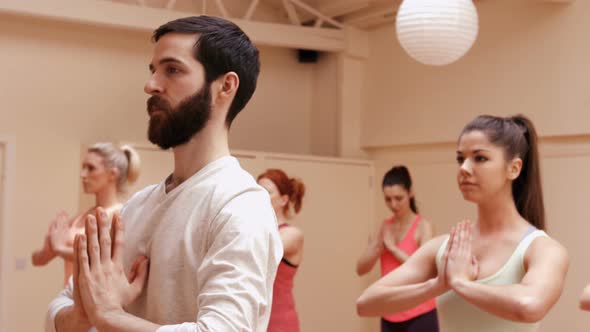 Group of people performing yoga alt