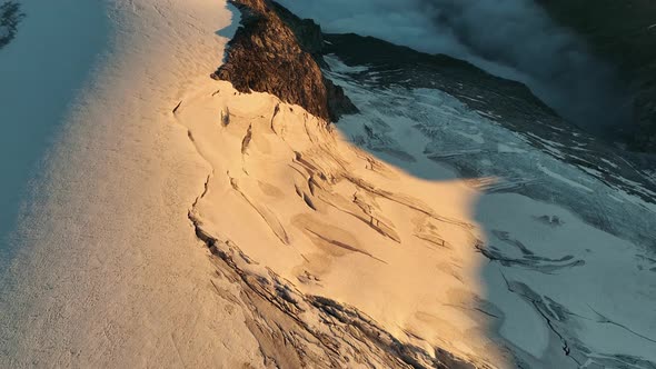 Glacier crevasses and fog-filled mountain valleys in the Austrian Alps. alt