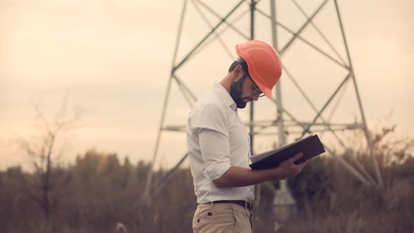 Energy Engineer Inspects Equipment High Voltage Substation.Industrial Transmission Power Engineering alt