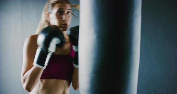 Athletic Woman Training Kickboxing in the Gym alt