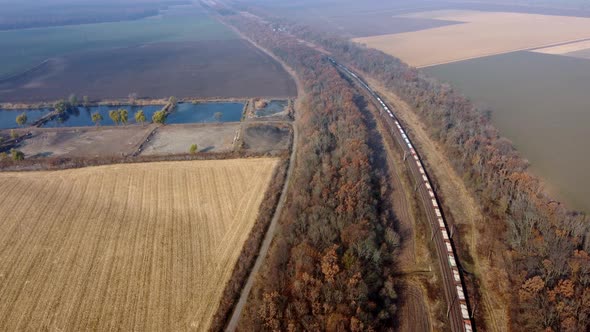 Panoramic Moving Freight Train Along Railway Tracks Trees Agricultural Fields alt