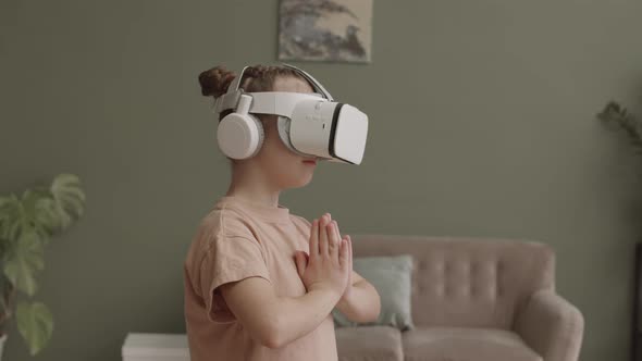 Little Girl in VR Headset Meditating at Home alt