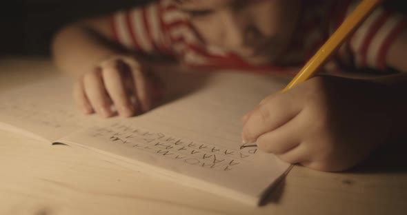 Left handed Boy Using Pencil and Practising Handwriting