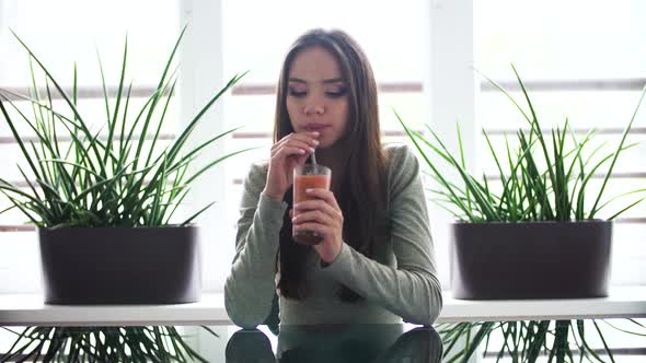 Woman On Diet Drinking Detox Smoothie Indoors alt