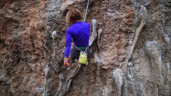 Slow Motion Smiling Tired but Happy Woman Rock Climber Hanging on Rope on Hard Challenge Route on alt