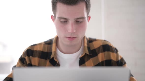 Close Up of Yawning Tired Young Man at Work alt
