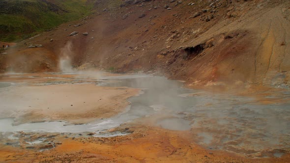 dramatic iceland landscape, geothermal hot spring steam smoke rising from the pools of hot water, kr