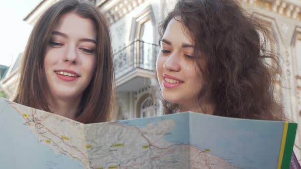 Cropped Shot of Two Young Women Using a Map