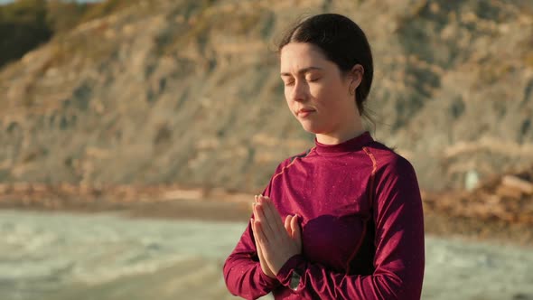 Portrait of a stressed woman meditating on the seashore. The concept of mental health. alt