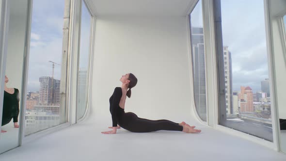 Yoga And Stretching At The Glass Balcony With City Skyline View