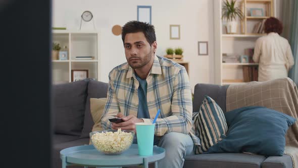 Mixed-Race Man Watching TV at Home alt