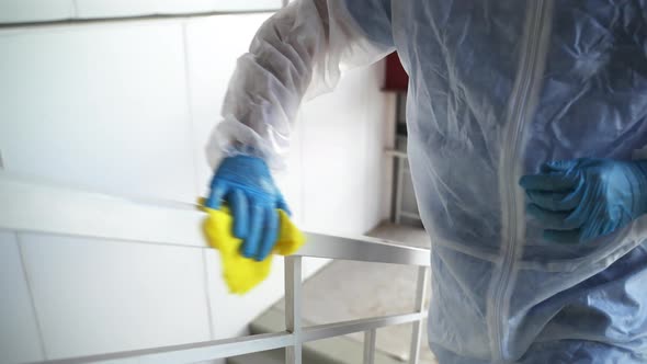 Disinfecting Service is Treating Public Place From Coronavirus Worker is Wiping Railing alt