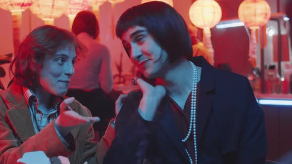 Transgender Man Having Fun with Multiethnic Friends in Bar alt