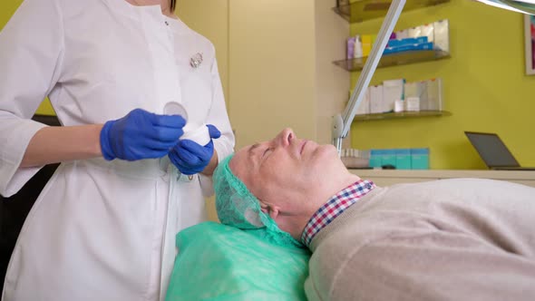 Doctor Preparing Skin of Mature Patient Before Skin Biorevitalization Procedure alt