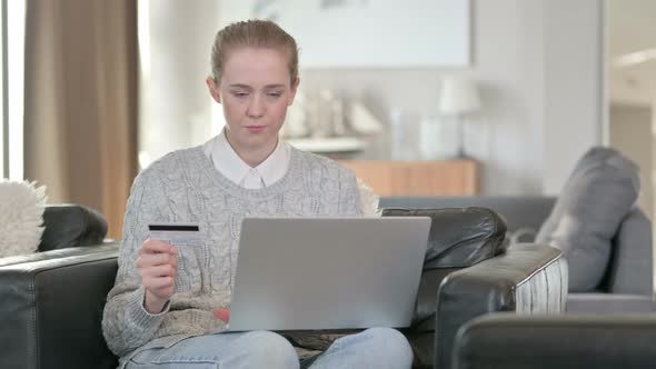 Successful Online Payment on Laptop By Young Woman at Home  alt