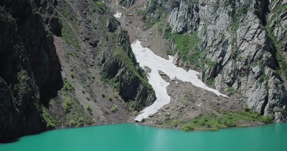 Mountain Lake of green and blue color Urungach. And Snow glacier. The beauty located in Uzbekistan, alt
