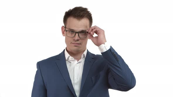 Handsome Young Businessman in Blue Suit Takingoff Glasses and Rubbing Eyes Feeling Tired From Work alt